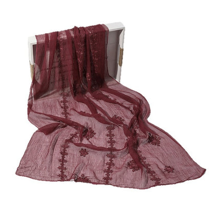 Folded Scarvii lightweight scarf highlighting intricate blossom stitch texture