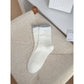 Flat lay of Rufia ribbed ruffle accent crew socks in pastel colors