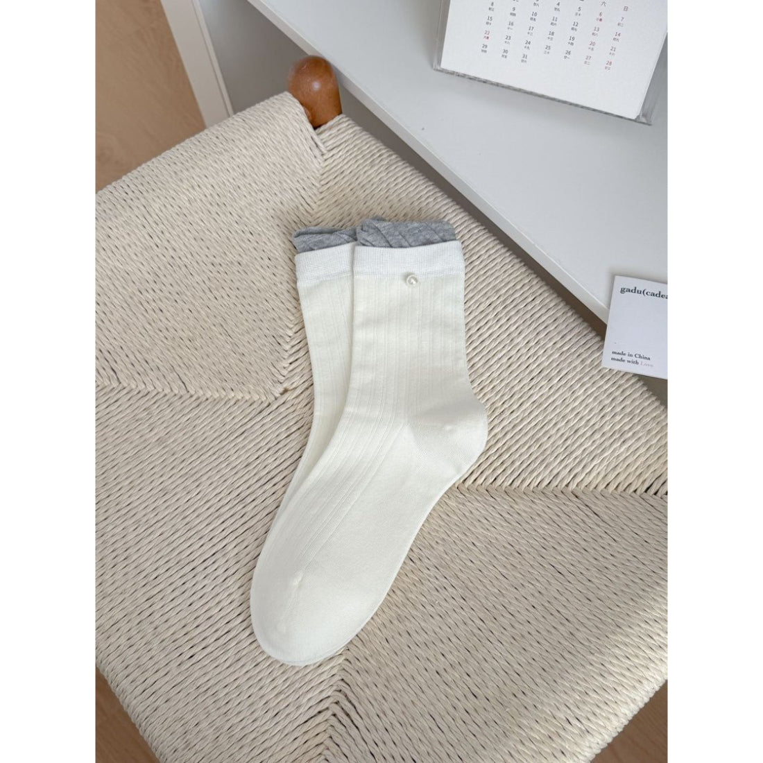 Flat lay of Rufia ribbed ruffle accent crew socks in pastel colors