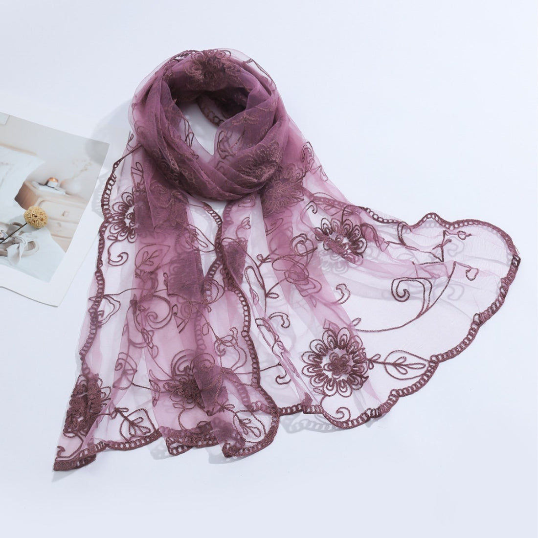 Close-up of delicate floral mesh pattern on lightweight sheer scarf