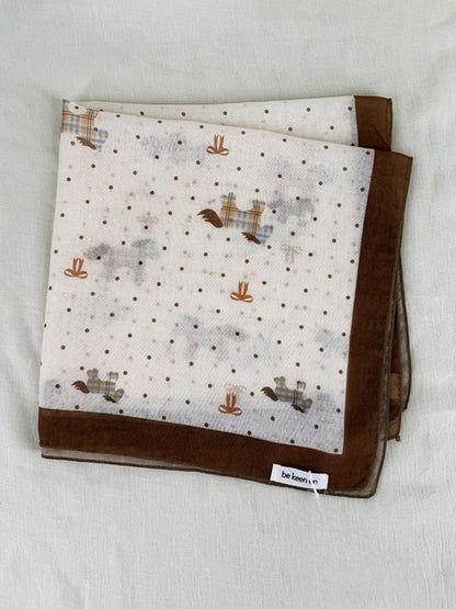 Scarvii Sheer Pony Dot Square Scarf draped over a chair highlighting lightweight sheer fabric