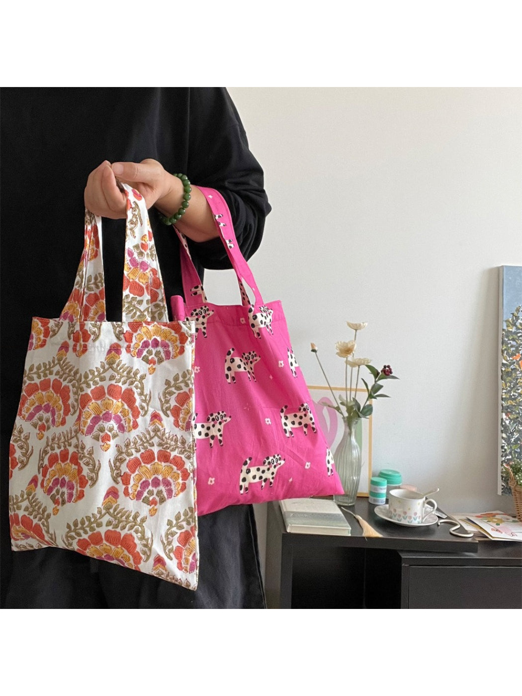 Cosbai tote bag held by a person showing size and usability