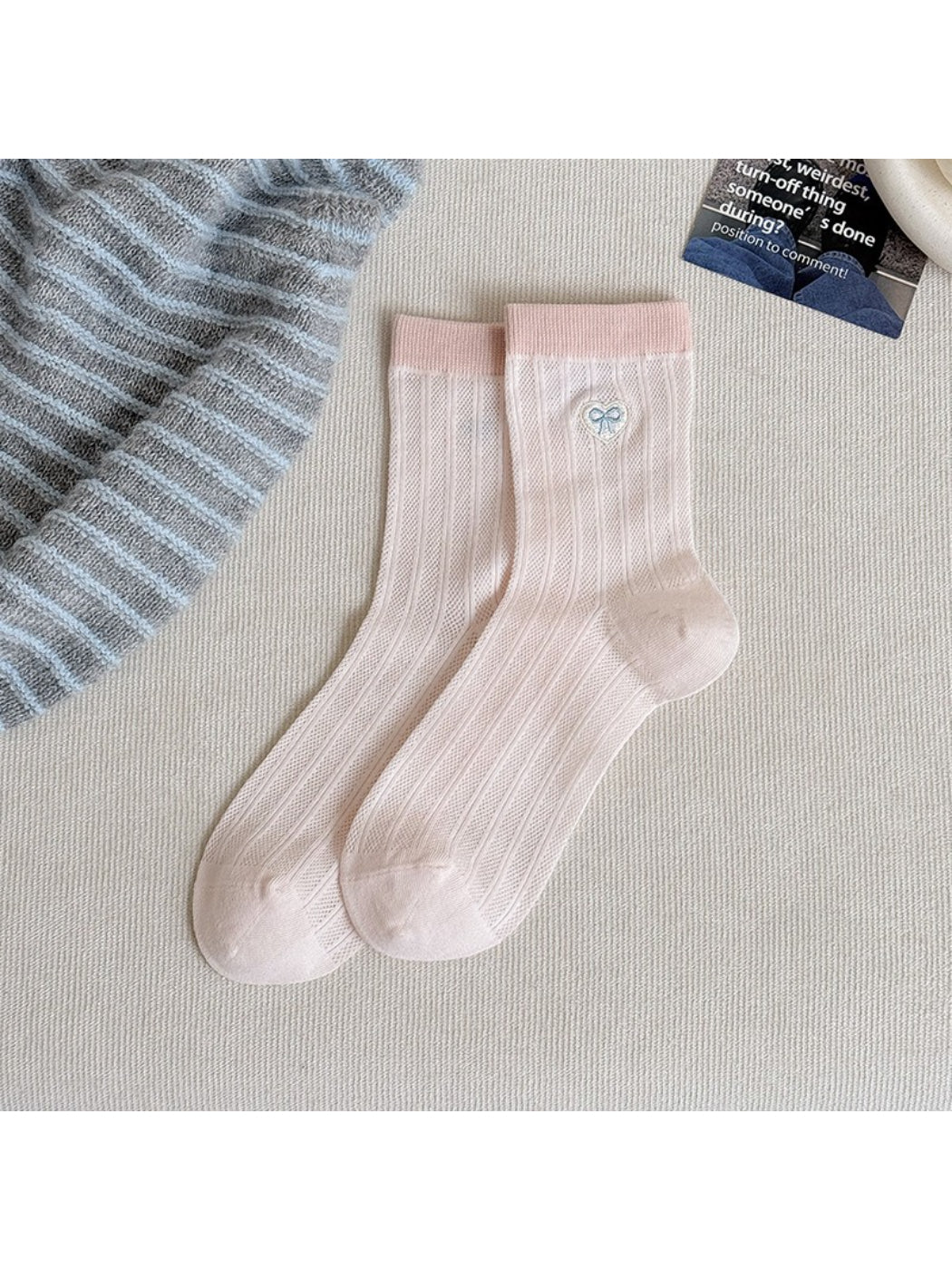 Flat lay of pastel socks with heart motifs arranged neatly