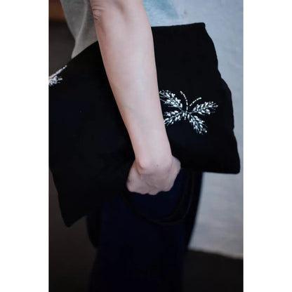 Black tote bag displayed on white background with beaded embellishments