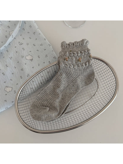 Rufia soft floral ribbed crew socks folded to highlight ribbed texture