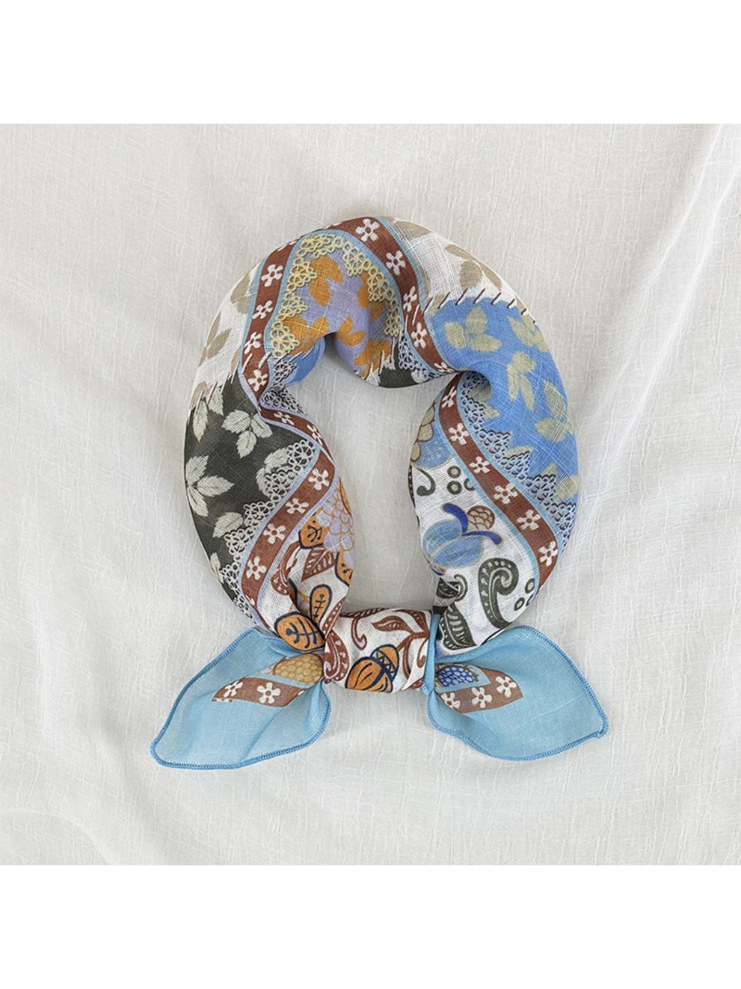 Scarvii patchwork floral border square scarf folded showing multicolor floral and geometric patterns