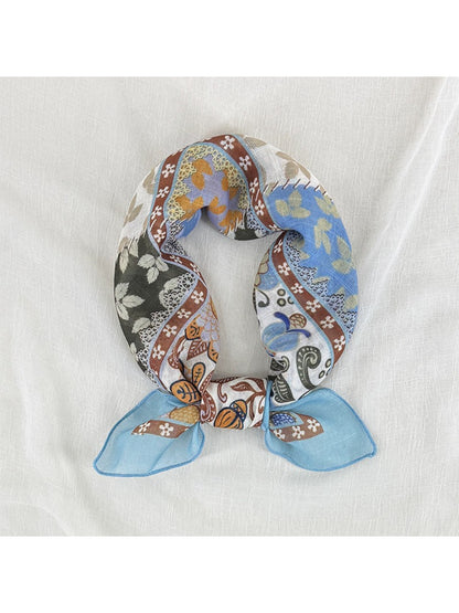 Scarvii patchwork floral border square scarf folded showing multicolor floral and geometric patterns