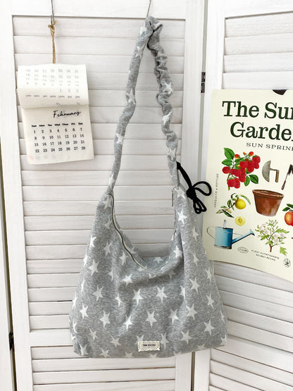 Side view of Cosbai star print slouchy shoulder bag showing strap detail