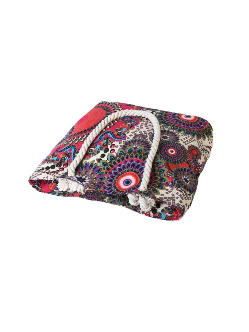 Large beach tote filled with beach essentials on a wooden surface