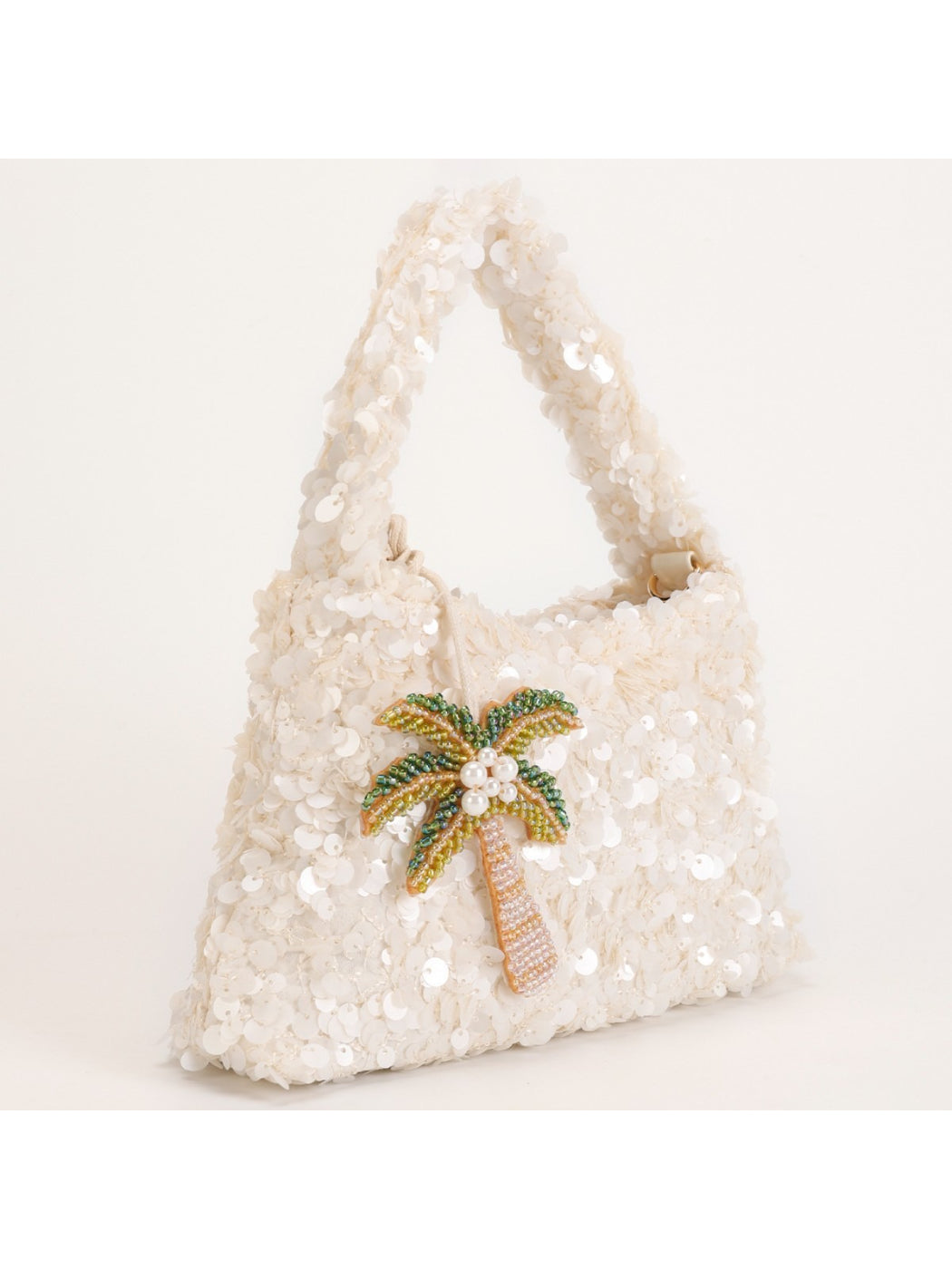 Close-up of colorful sequins forming tropical palm leaves on Cosbai handbag
