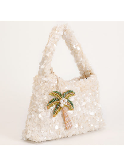 Close-up of colorful sequins forming tropical palm leaves on Cosbai handbag