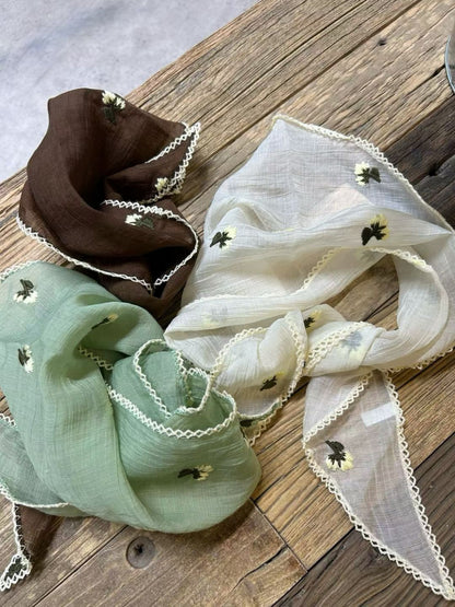 Flat lay of Scarvii vintage floral triangle bandana scarf highlighting its triangular shape and colors