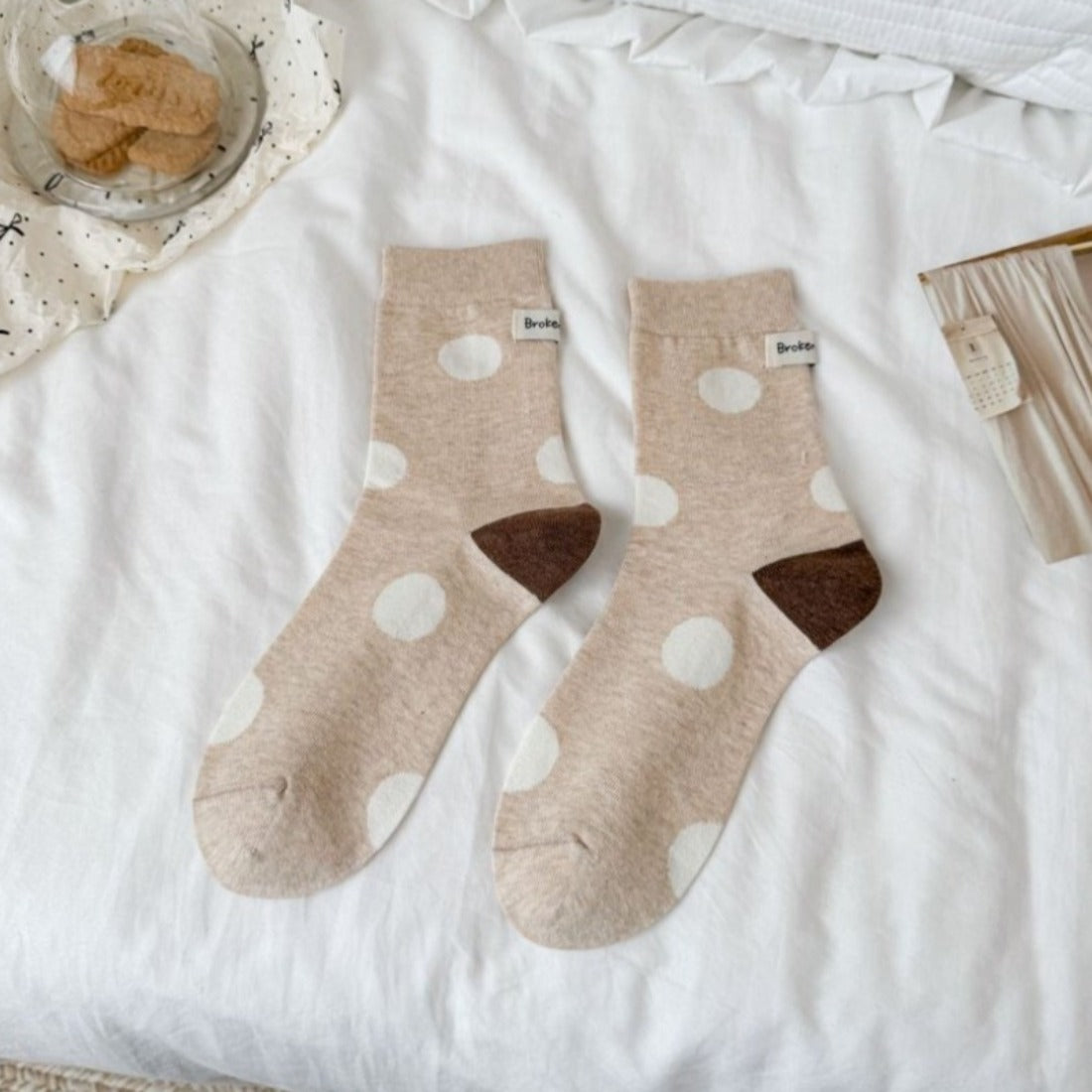 Rufia socks worn on feet showing black heel and toe with white and black dot pattern