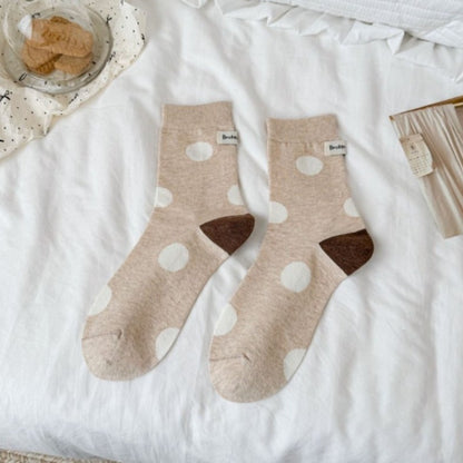 Rufia socks worn on feet showing black heel and toe with white and black dot pattern