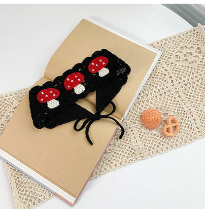 Detailed shot of Haila crochet mushroom hairband showing yarn texture and mushroom design