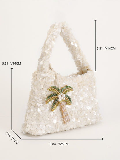 Model holding Cosbai Tropical Sequin Handbag with tropical leaf pattern and gold chain