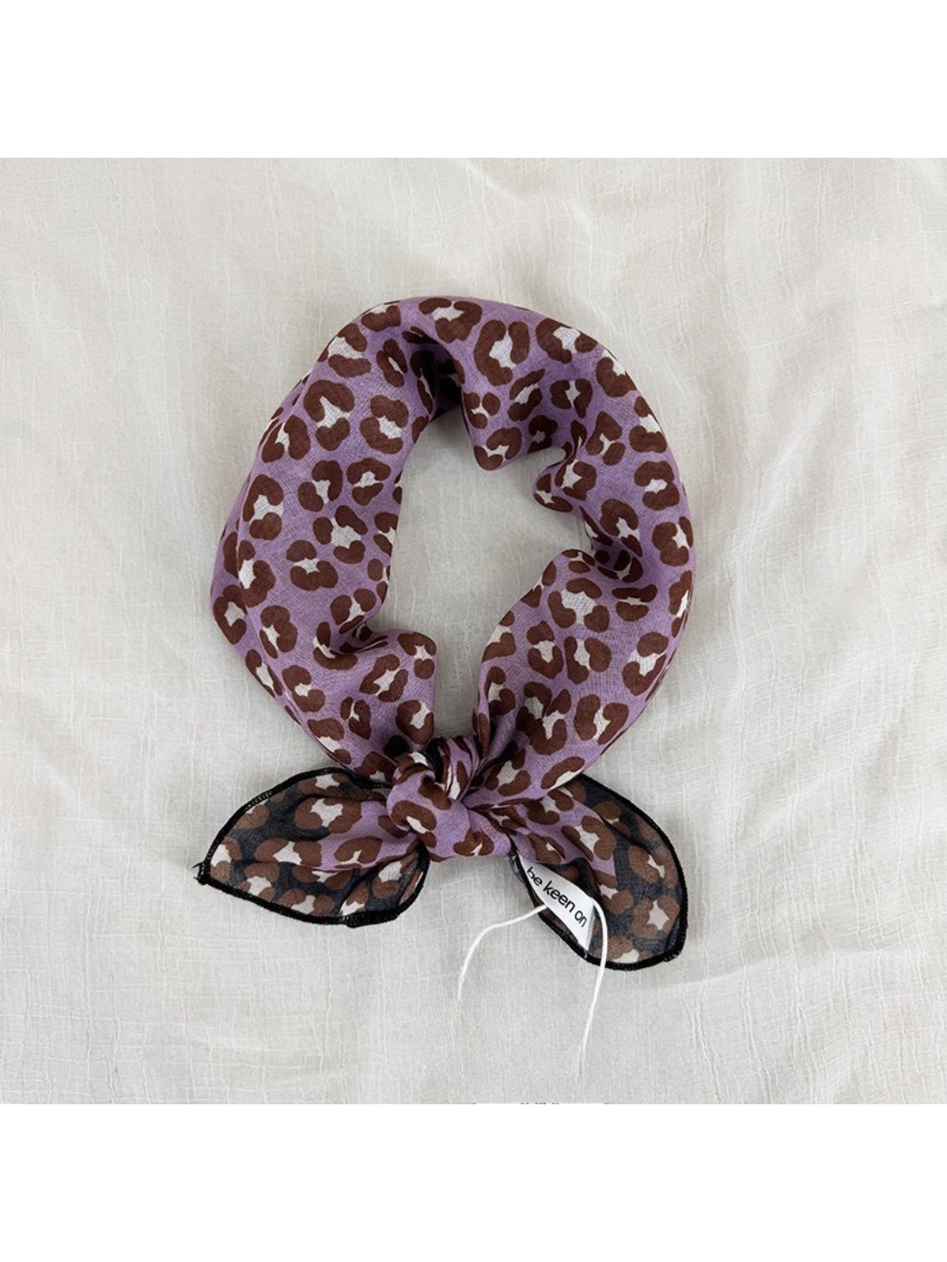 Scarvii leopard print square scarf folded to show pattern and texture