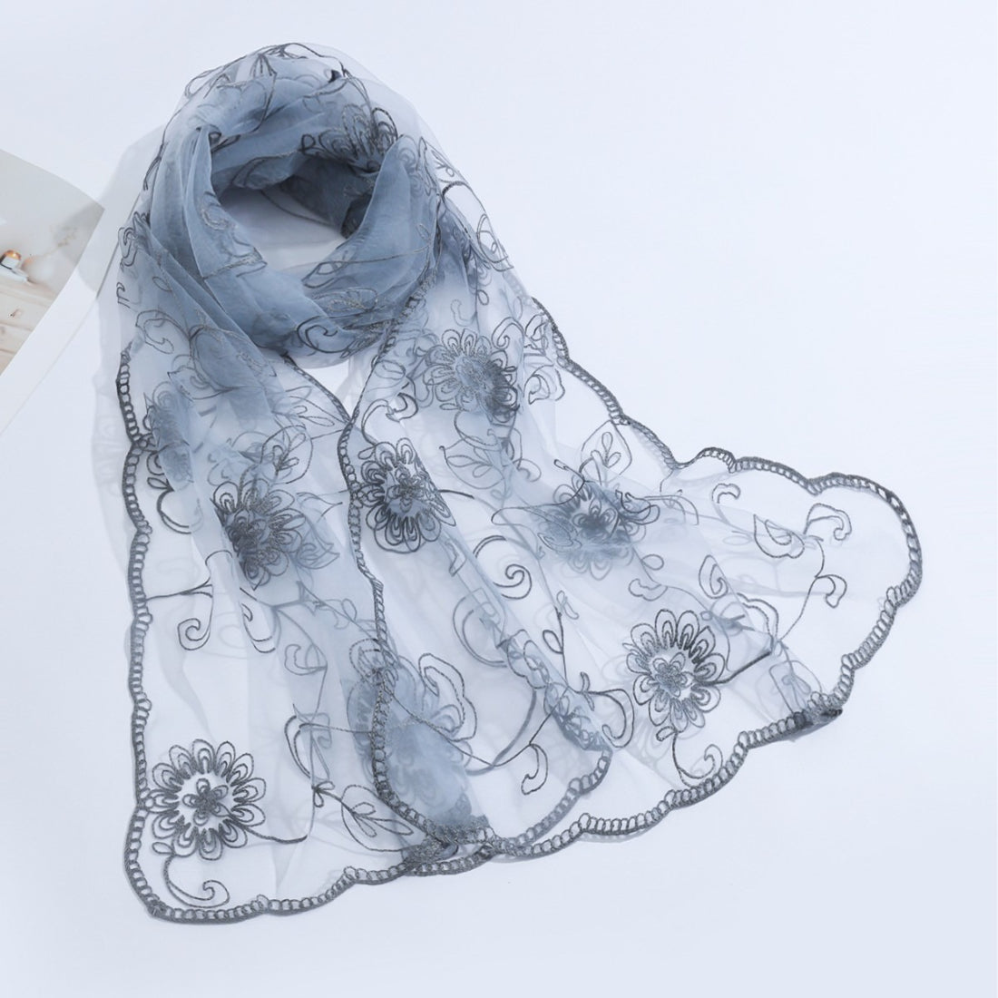 Floral mesh scarf styled as a head wrap on a model