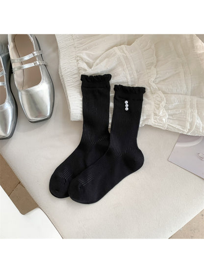 Close-up of ribbed texture and delicate trim on Rufia crew socks in beige