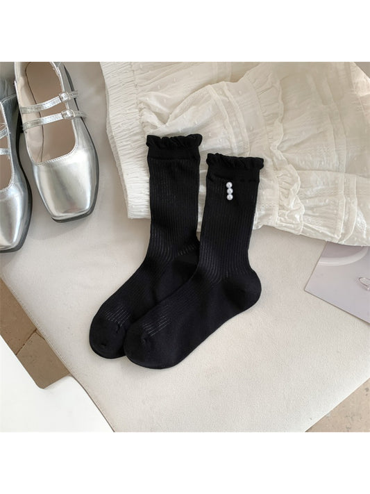 Close-up of ribbed texture and delicate trim on Rufia crew socks in beige