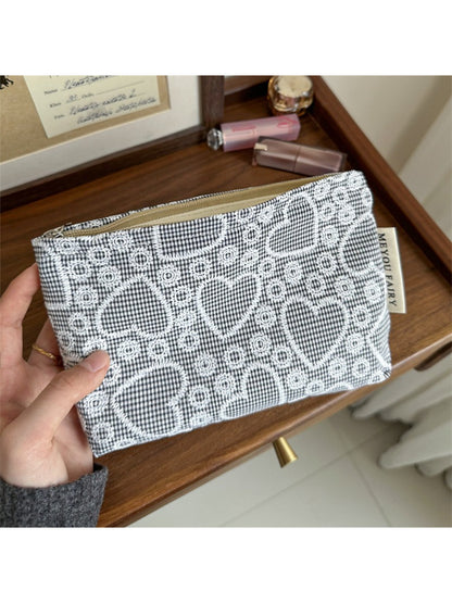 Cosbai makeup bag with heart pattern displayed on a wooden table