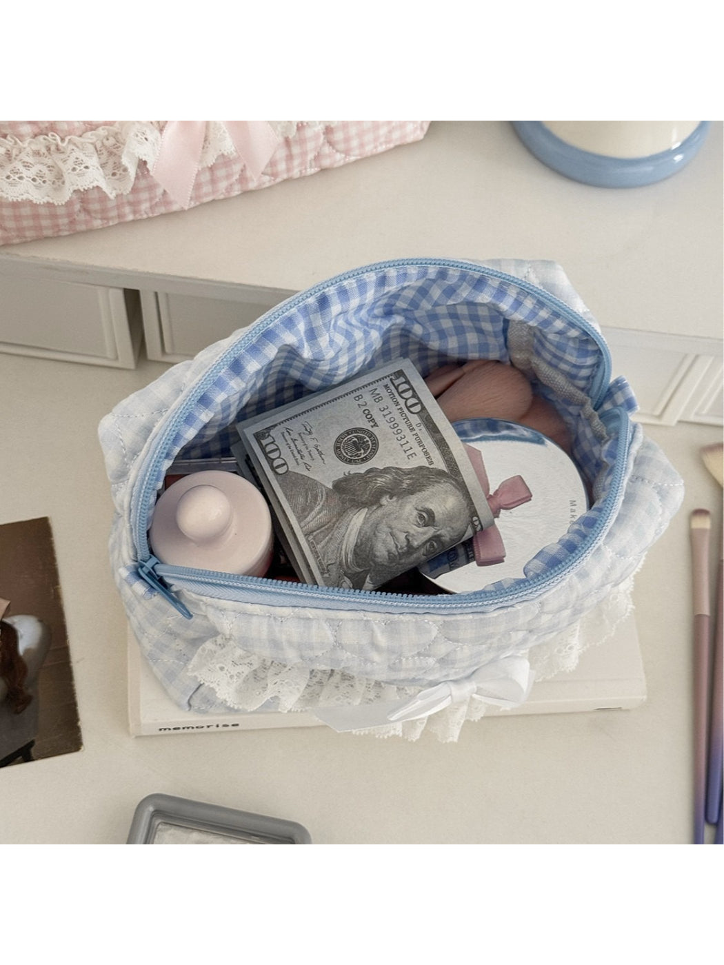 Close-up of lace bow on gingham cosmetic pouch by Cosbai