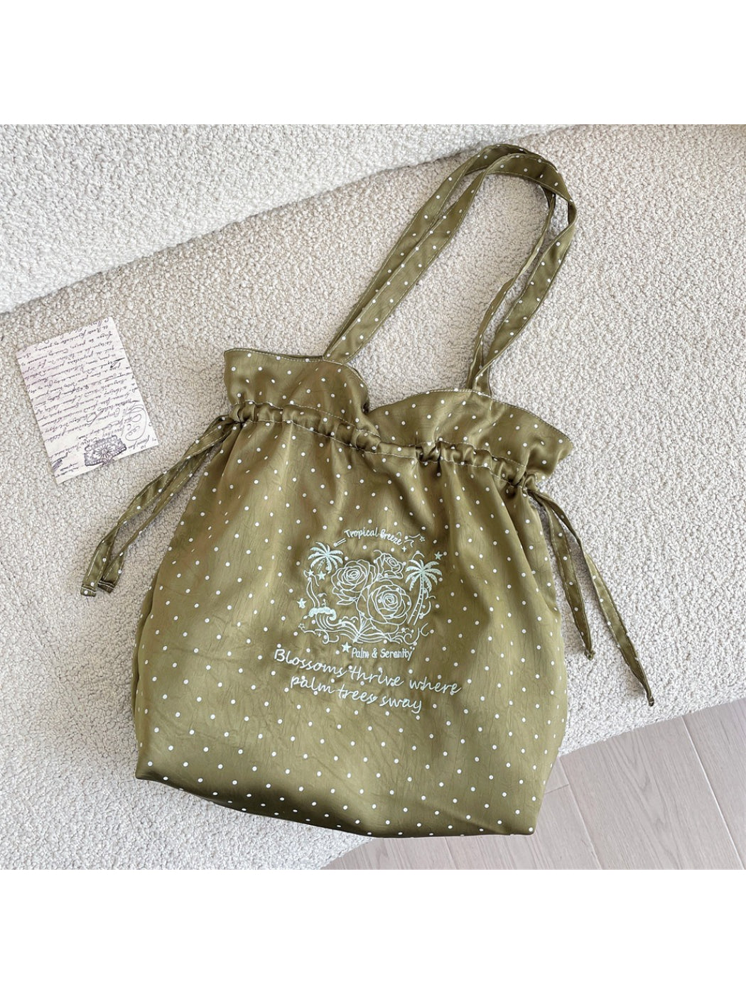 Cosbai polka dot bag worn over shoulder on model showing size and fit