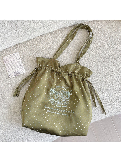 Cosbai polka dot bag worn over shoulder on model showing size and fit