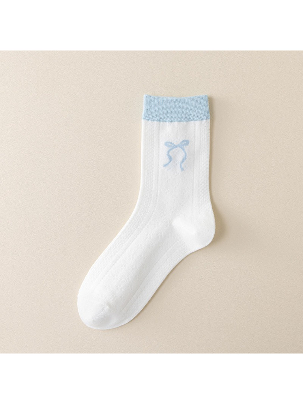 Side view of Rufia blue accent crew socks on a model's feet