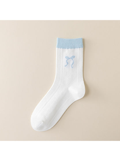 Side view of Rufia blue accent crew socks on a model's feet