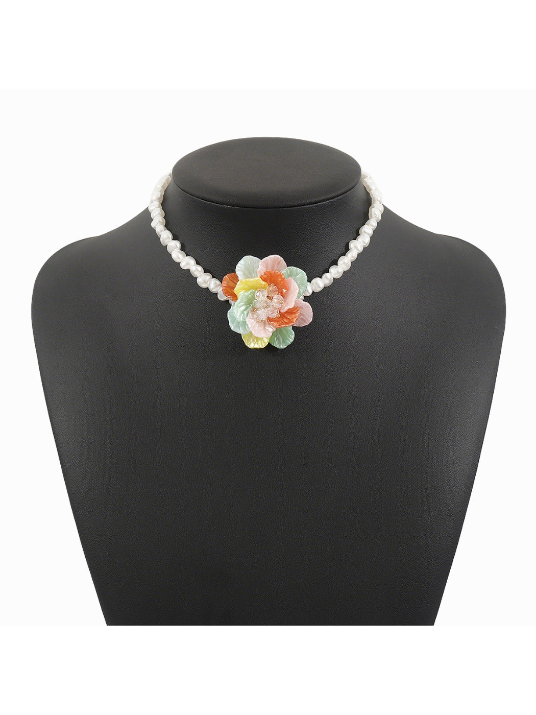 White beaded flower necklace coiled neatly with focus on flower centerpiece