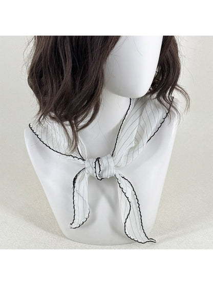 Scarvii pleated triangle scarf with black and white contrast trim laid flat