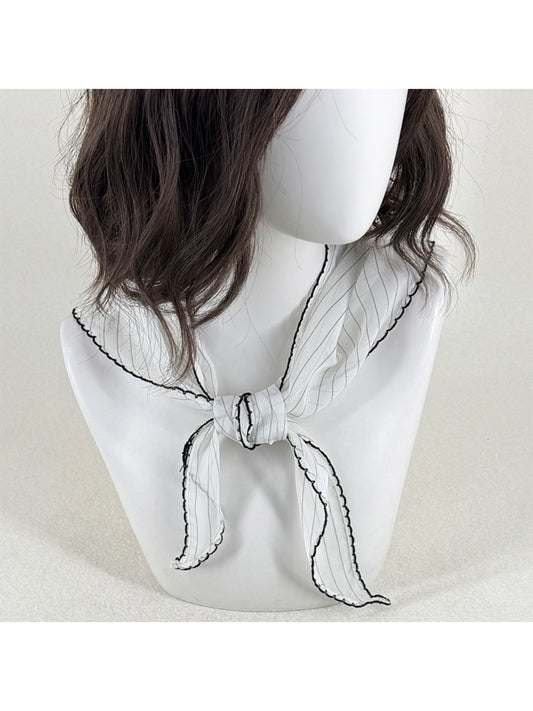 Scarvii pleated triangle scarf with black and white contrast trim laid flat