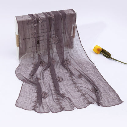 Scarvii scarf hanging to display full length and delicate blossom stitch work