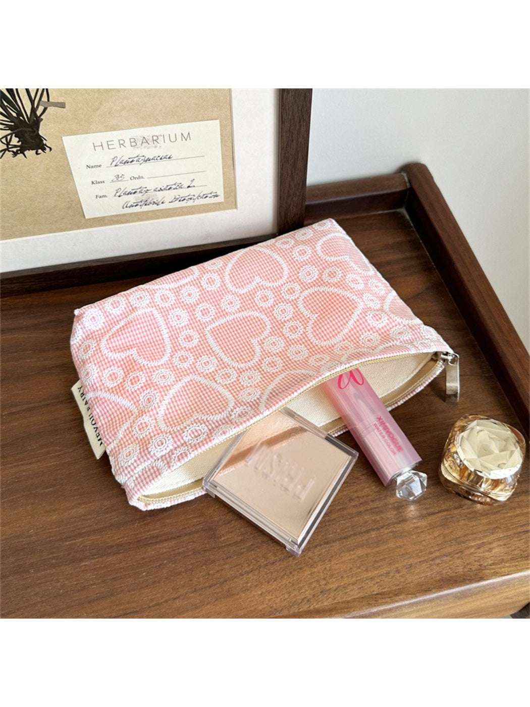 Cosbai makeup bag partially open, revealing pink interior