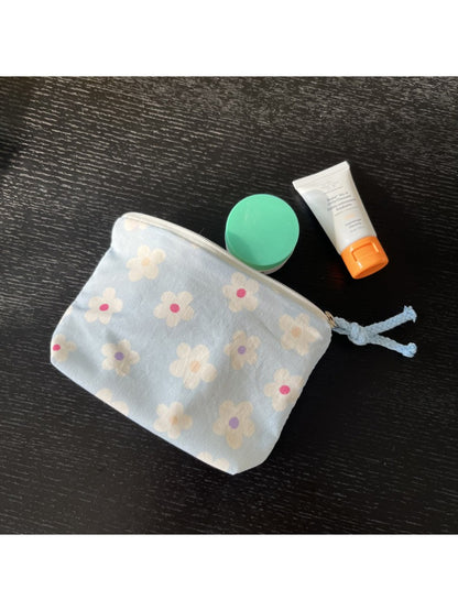 Cosbai mini pouch bag placed on a flat surface with floral pattern visible