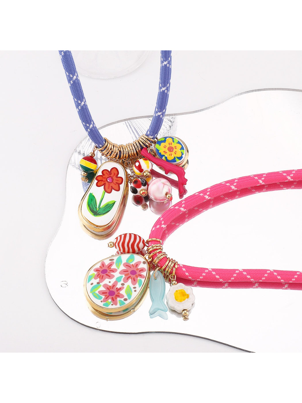 Multi charm rope necklace coiled to show colourful beads and silver charms