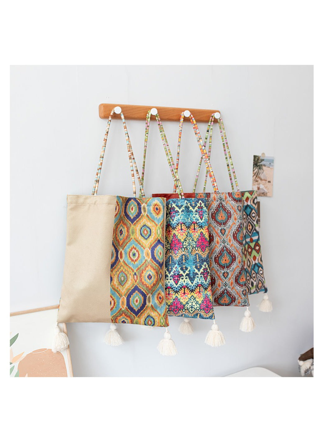 Cosbai Boho Ethnic Tassel Tote bag with colorful ethnic pattern and tassels hanging on hook