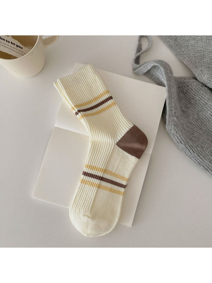 Side view of Rufia ribbed socks highlighting the colour block sections in pink, blue, and cream