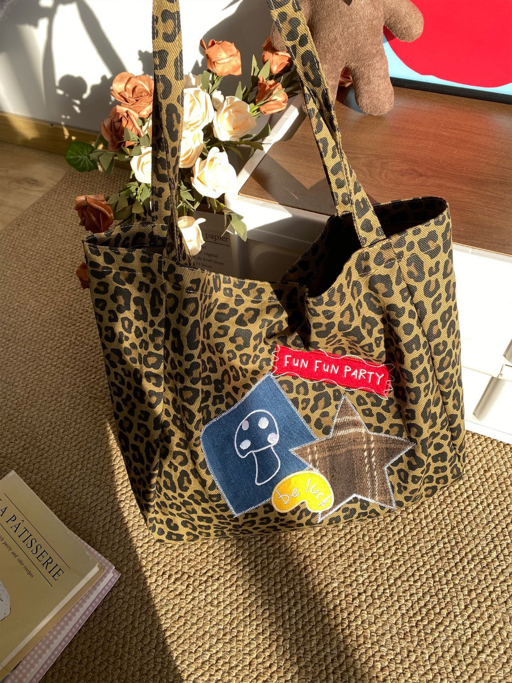 Model carrying Cosbai leopard print bag over shoulder in outdoor street setting