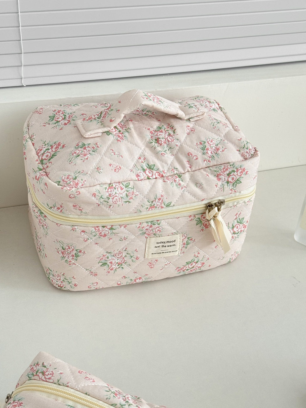 Close-up of quilted flower pattern and stitching on Cosbai beauty storage case