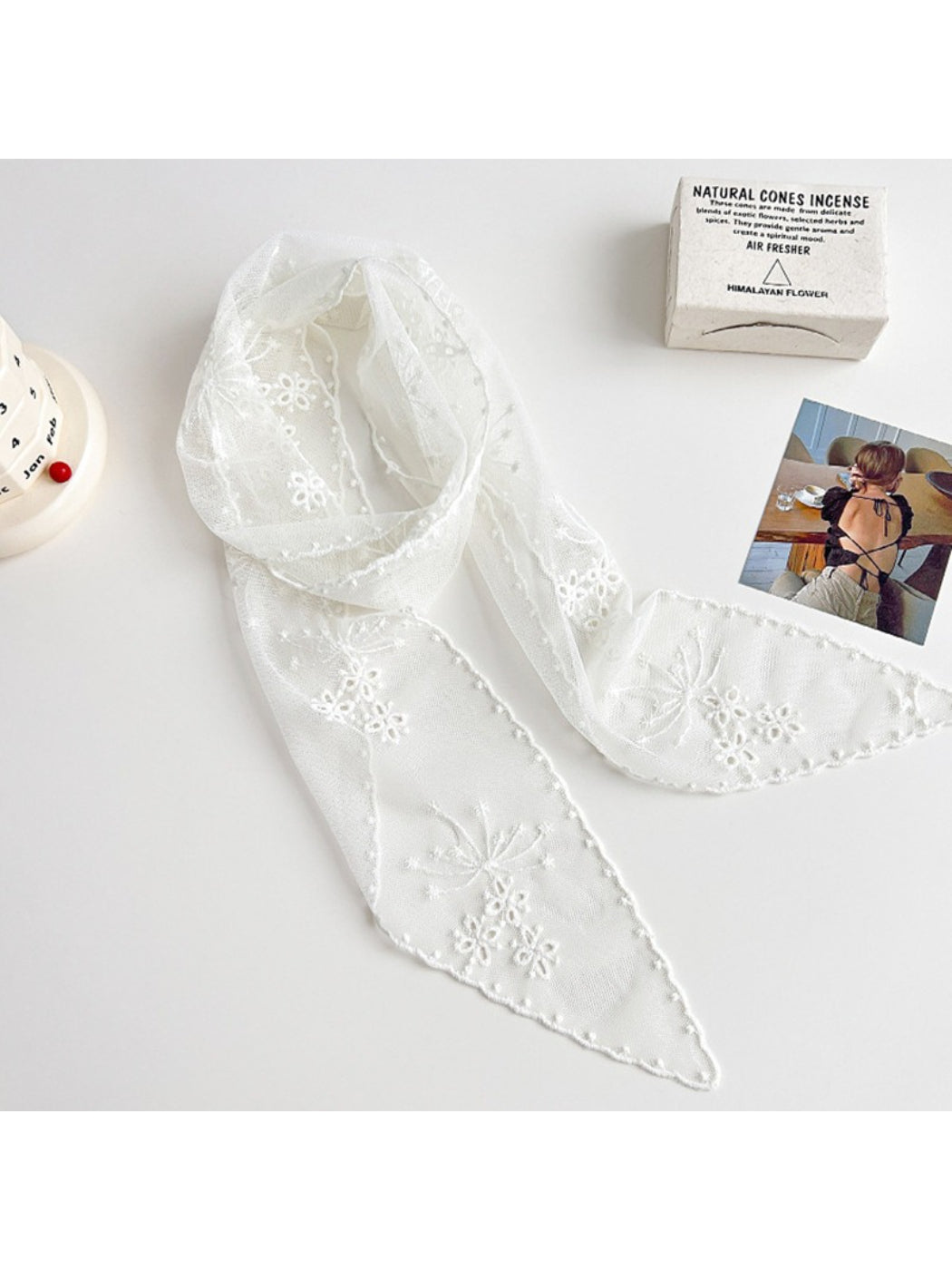Close-up of Scarvii floral mesh skinny scarf fabric texture and detailed flower design
