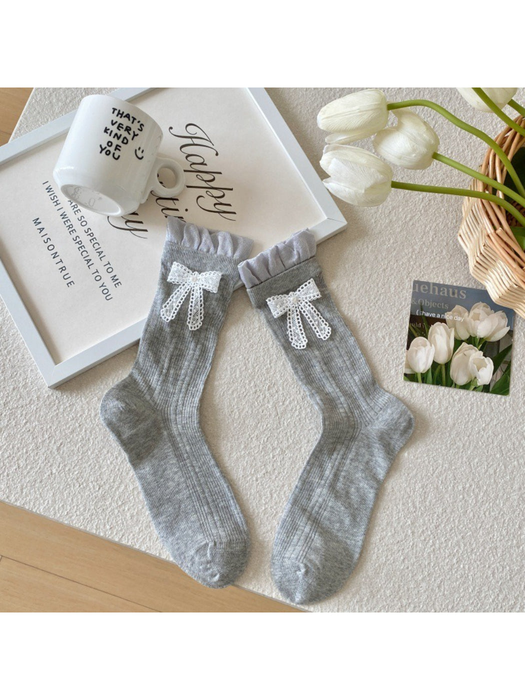 Rufia socks displayed with folded cuff and ribbon accent