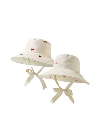 Side view of Haila reversible gingham brim hat showing black and white check design