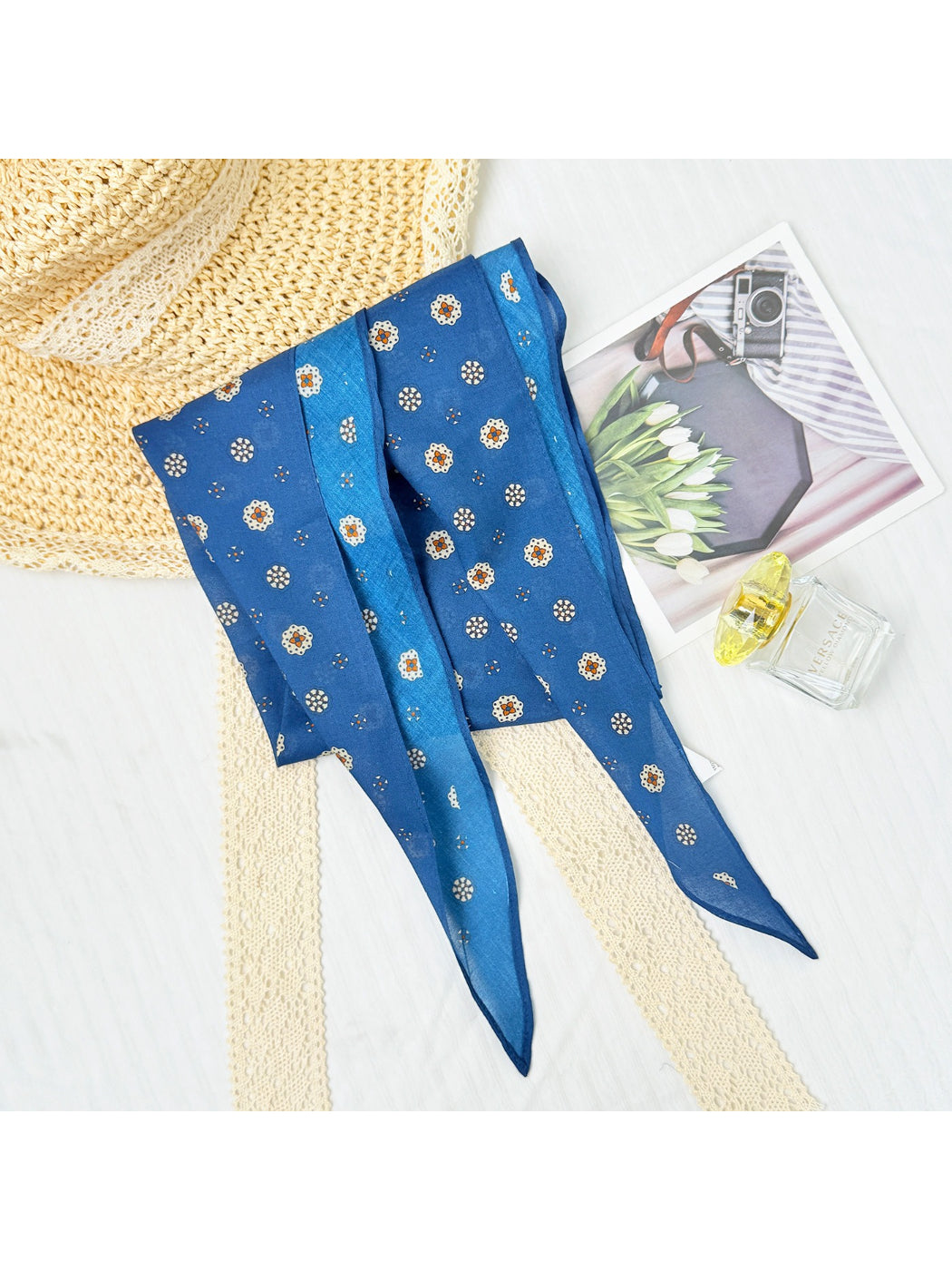 Scarvii scarf folded and placed on wooden surface showcasing colors and print