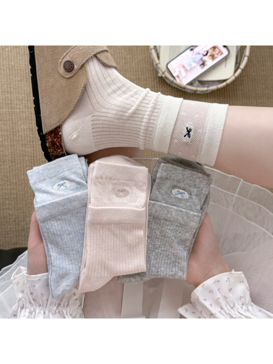 Close-up of Rufia embroidered mesh mid-calf socks showing detailed embroidery
