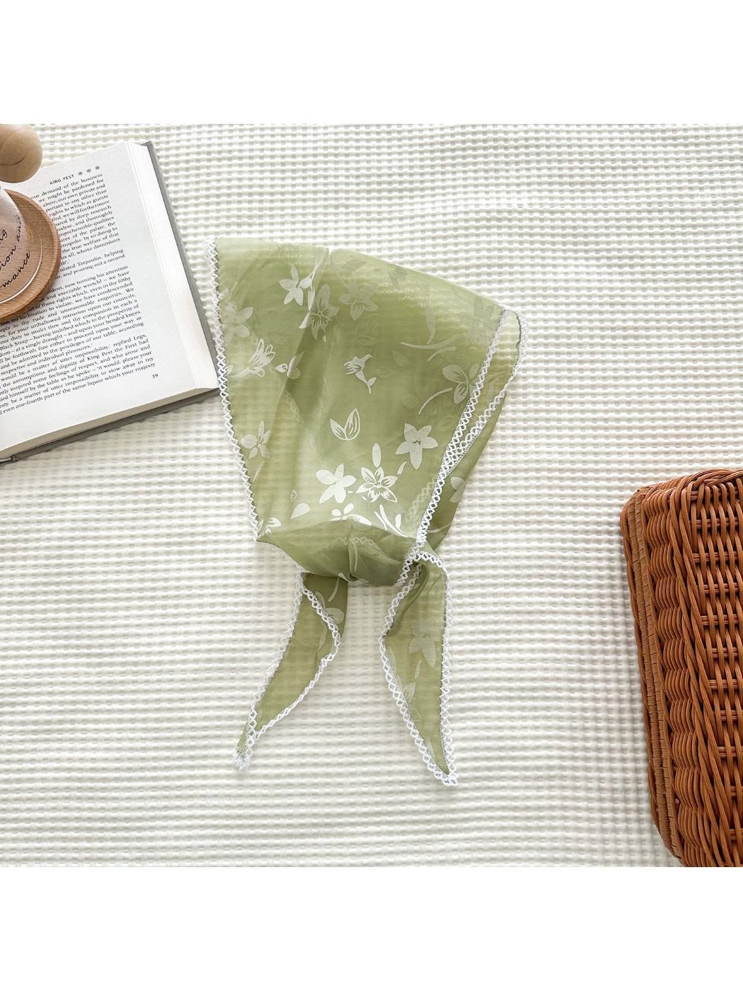 Triangle scarf draped over shoulders highlighting lightweight and translucent material