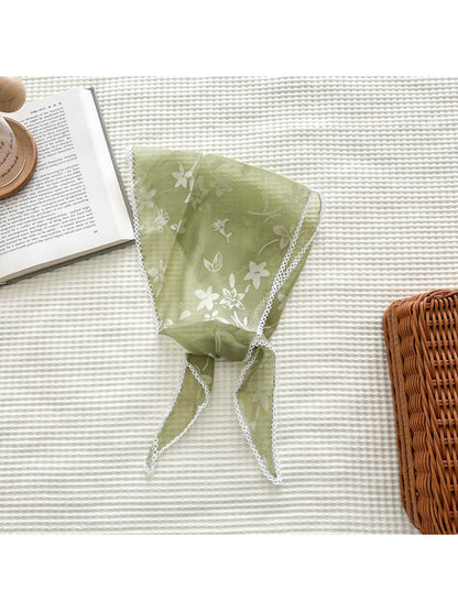 Triangle scarf draped over shoulders highlighting lightweight and translucent material
