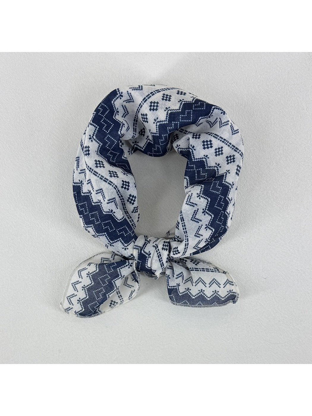 Scarvii geometric pattern square scarf folded showing blue and beige design
