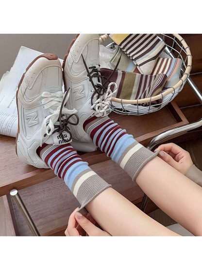 Close-up of Rufia socks showing detailed bow pattern and colorblock design